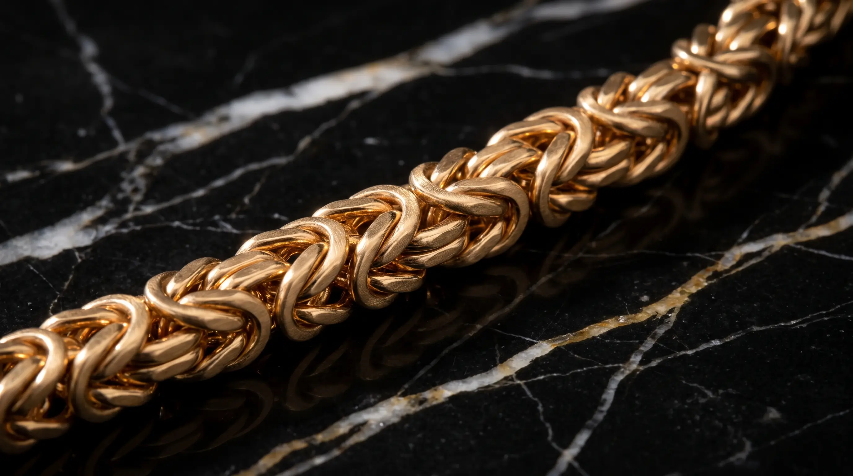 Gold_woven_chain_on_marble_202607191724 (1)